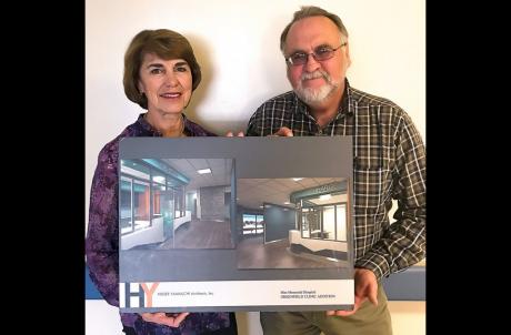 Mee Memorial Hospital CEO Susan Childers and Manager of Plant Operations Jim Johnson hold up renderings of the new Greenfield Clinic expansion.