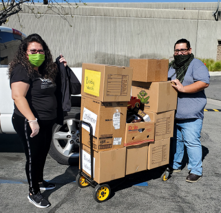 Two Inland Empire Health Plan staff delivering food and supplies.